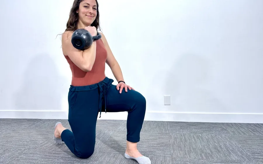 Woman performing a kettlebell rack lunge