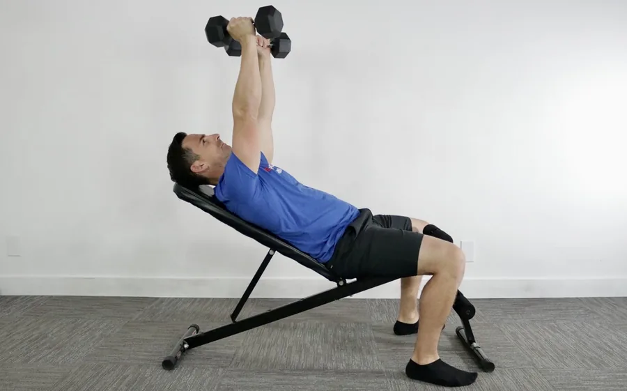 Man performing an incline dumbbell chest press