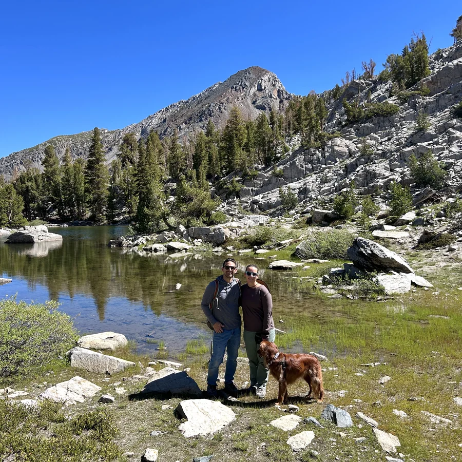Sebastian Gonzales hiking with his dog at a mountain lake